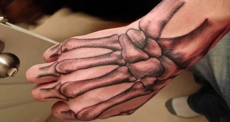 50 Incredible Skeleton Hand Tattoo Designs With Meaning 2024