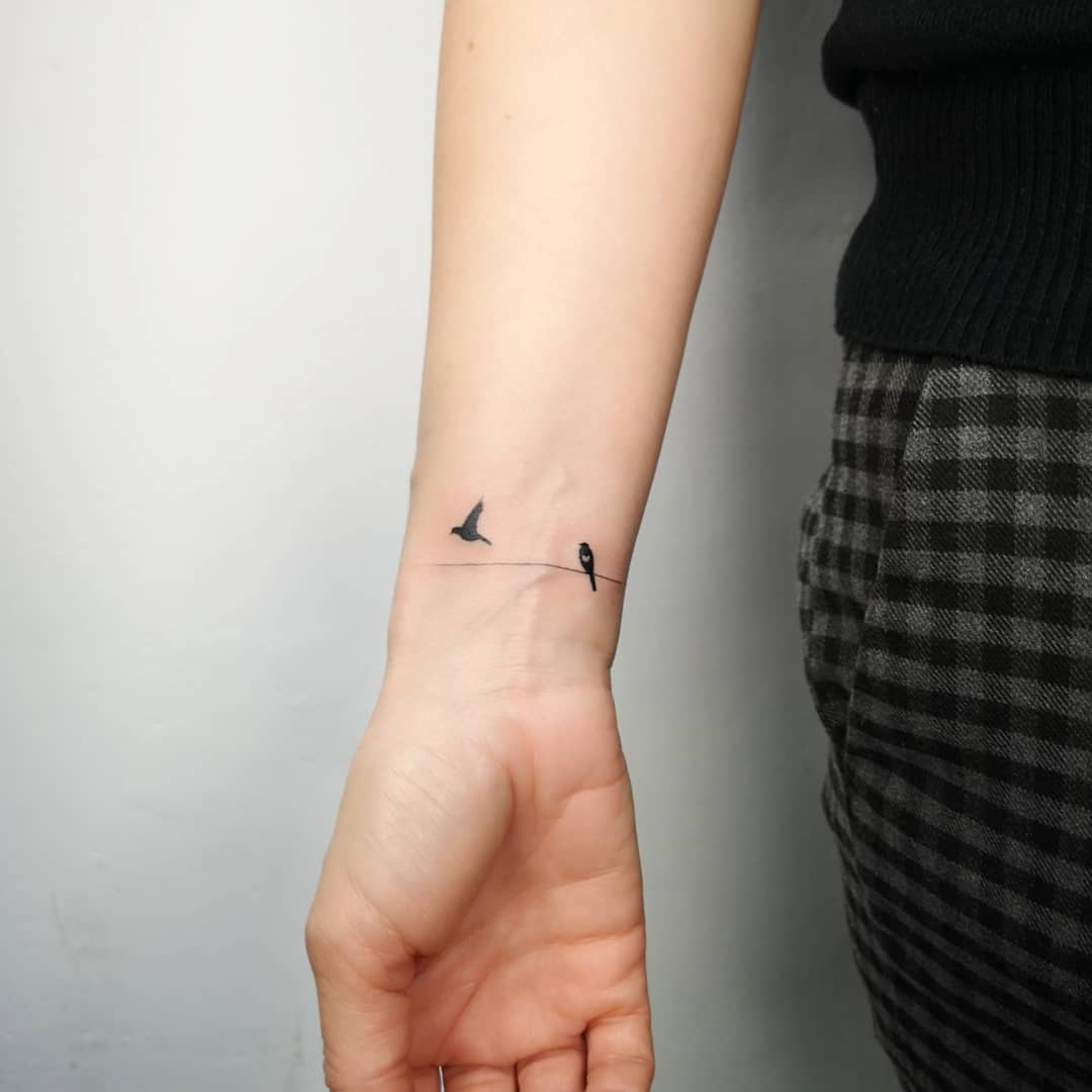 A Small Bird Tattoo On The Arm