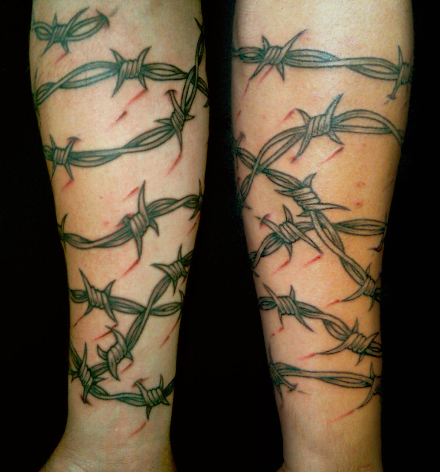 A Tattoo With Barbed Wire On The Arm