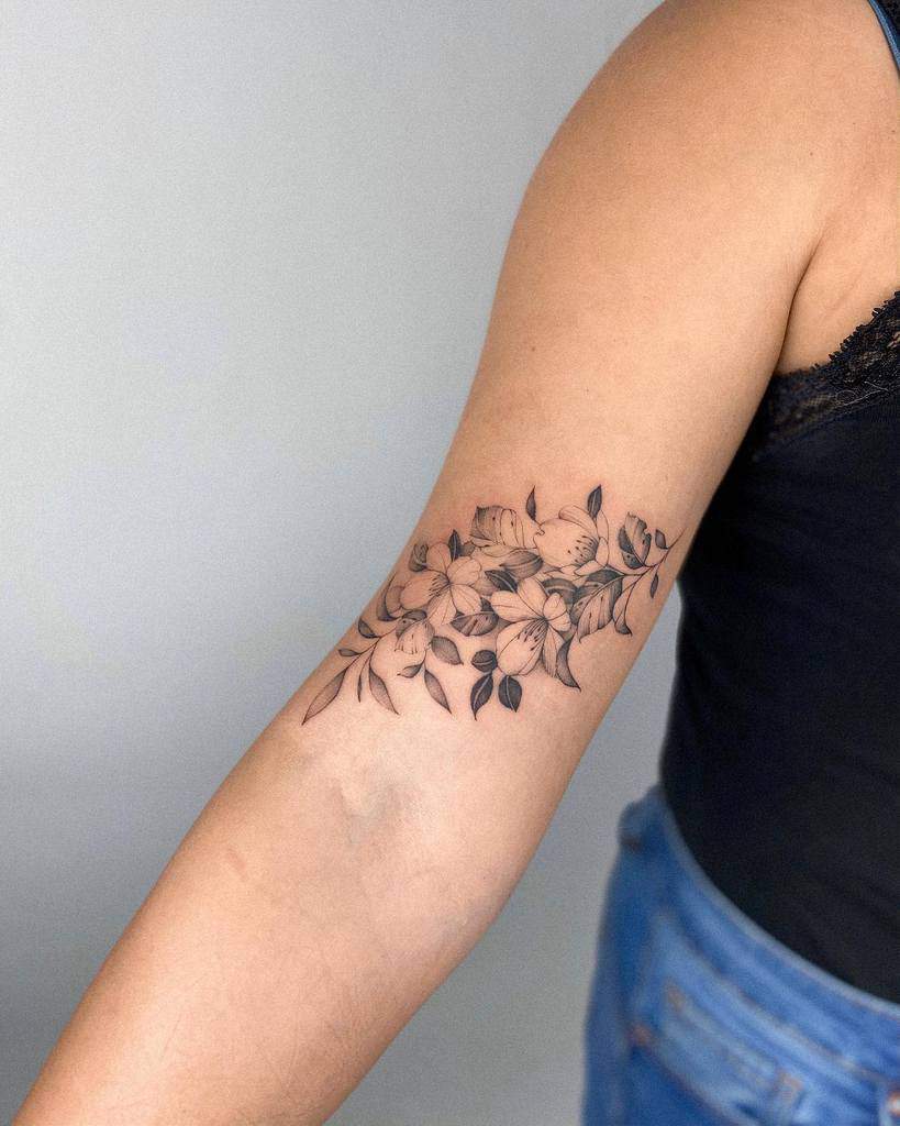 A Woman S Arm With A Flower Tattoo On The Left Side Of Her Arm