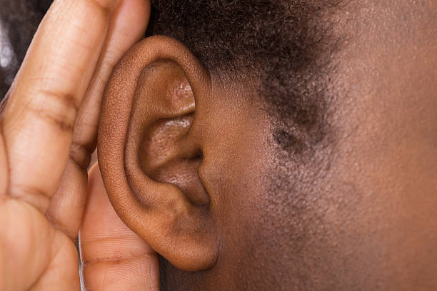 A Woman S Ear With Leaves On It And A Black Heart Behind The Ear