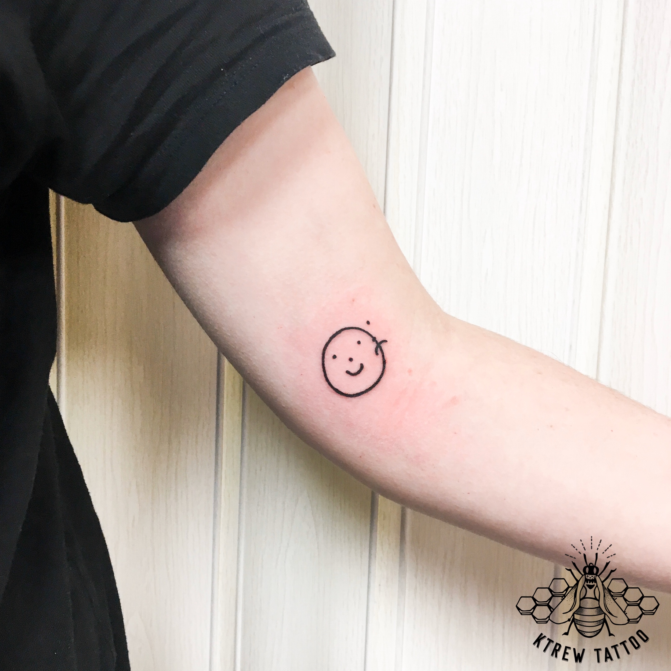 Happy Sad Face Tattoo Placed On The Inner Forearm