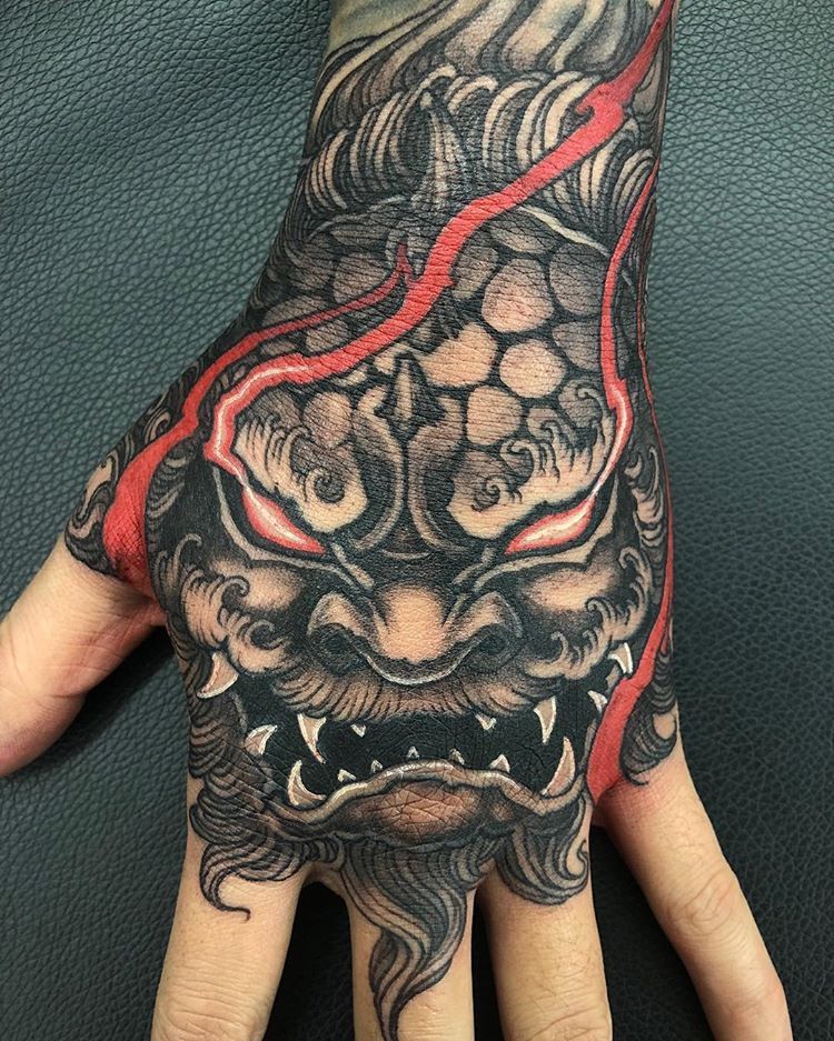 Oni Mask Hand Tattoo: Bold and Mystical Ink