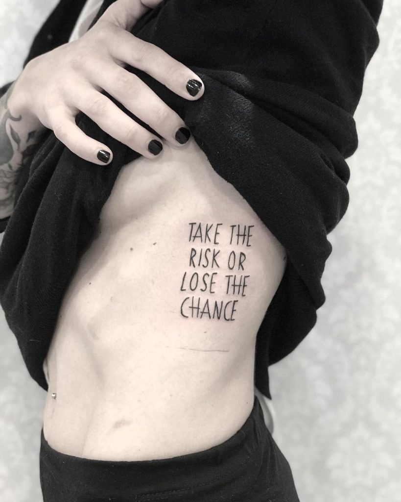 Quote Take The Risk Or Lose The Chance Tattoo Inked On The Left Rib