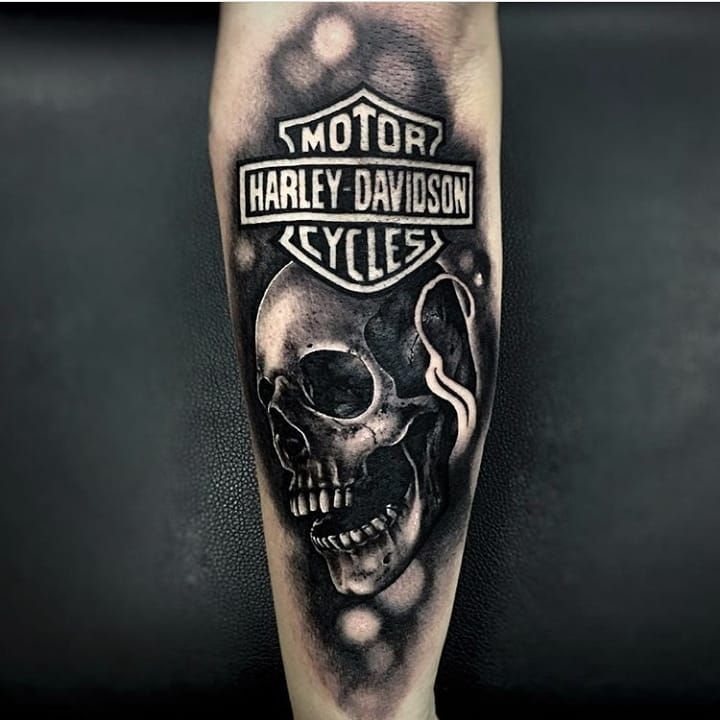 Realist Black And Grey Harley Davidson Logo And Skull Tattoo Done By