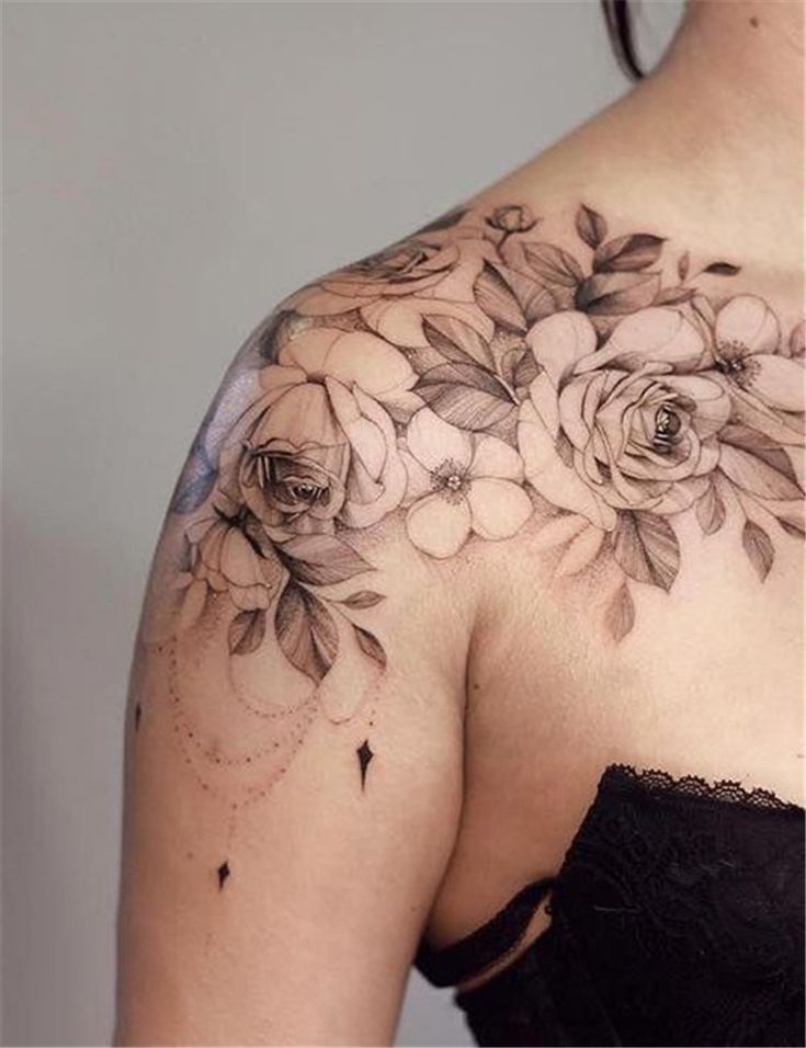 The Back Of A Woman S Shoulder With Flowers On It